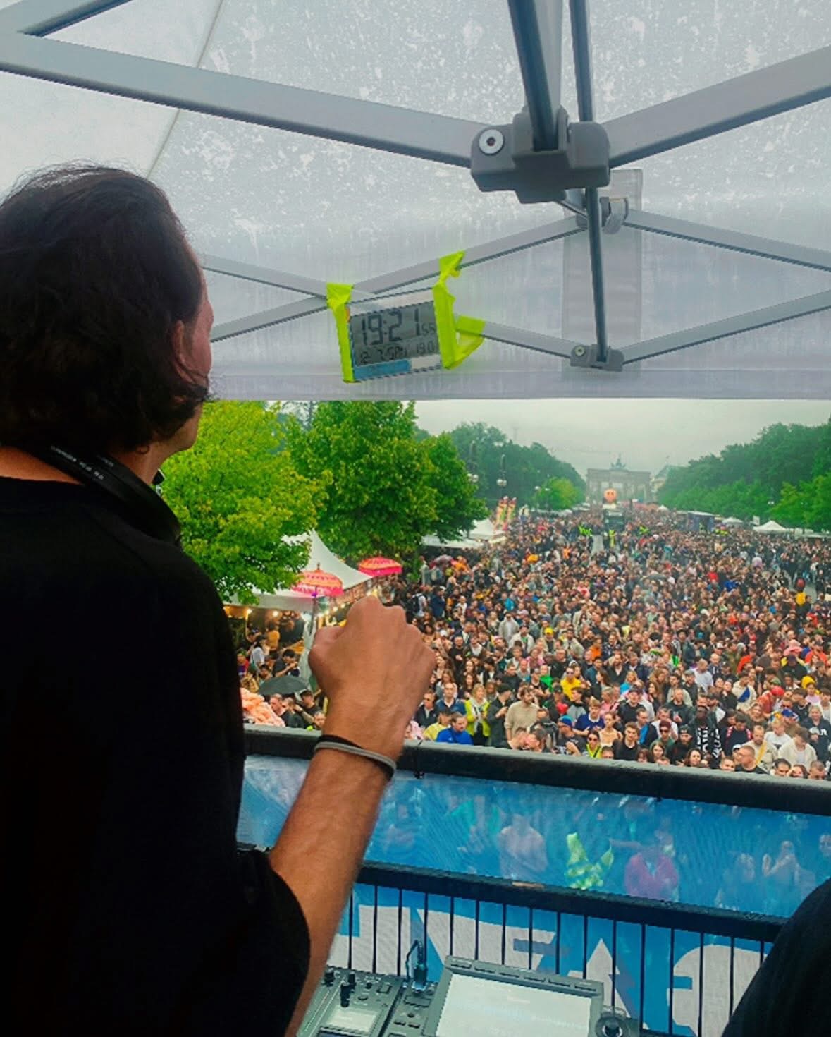 Marc DJing at the Rave The Planet Float, beneath him a huge crowd of people